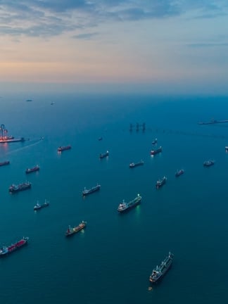 Ships moored at sea at sunset - aerial view